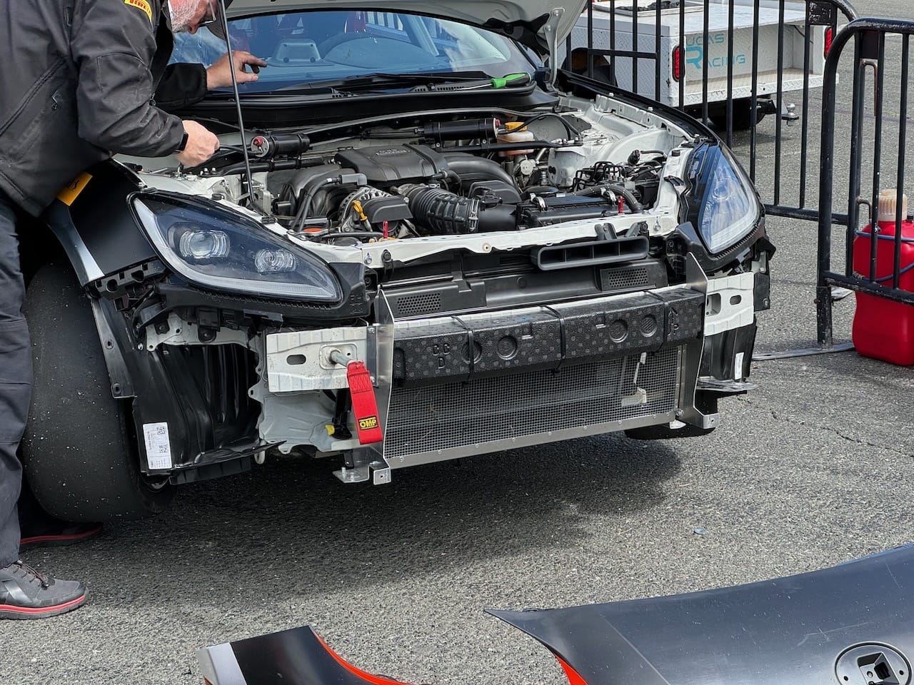 You can see the custom radiator shroud, grill, and splitter support in this photo, taken during tech inspection at Sonoma 2024. Also note the custom 3D printed intake, which is different than some aftermarket designs based on the GR Cup car. The factory plastic shroud above the crash bar is retained.