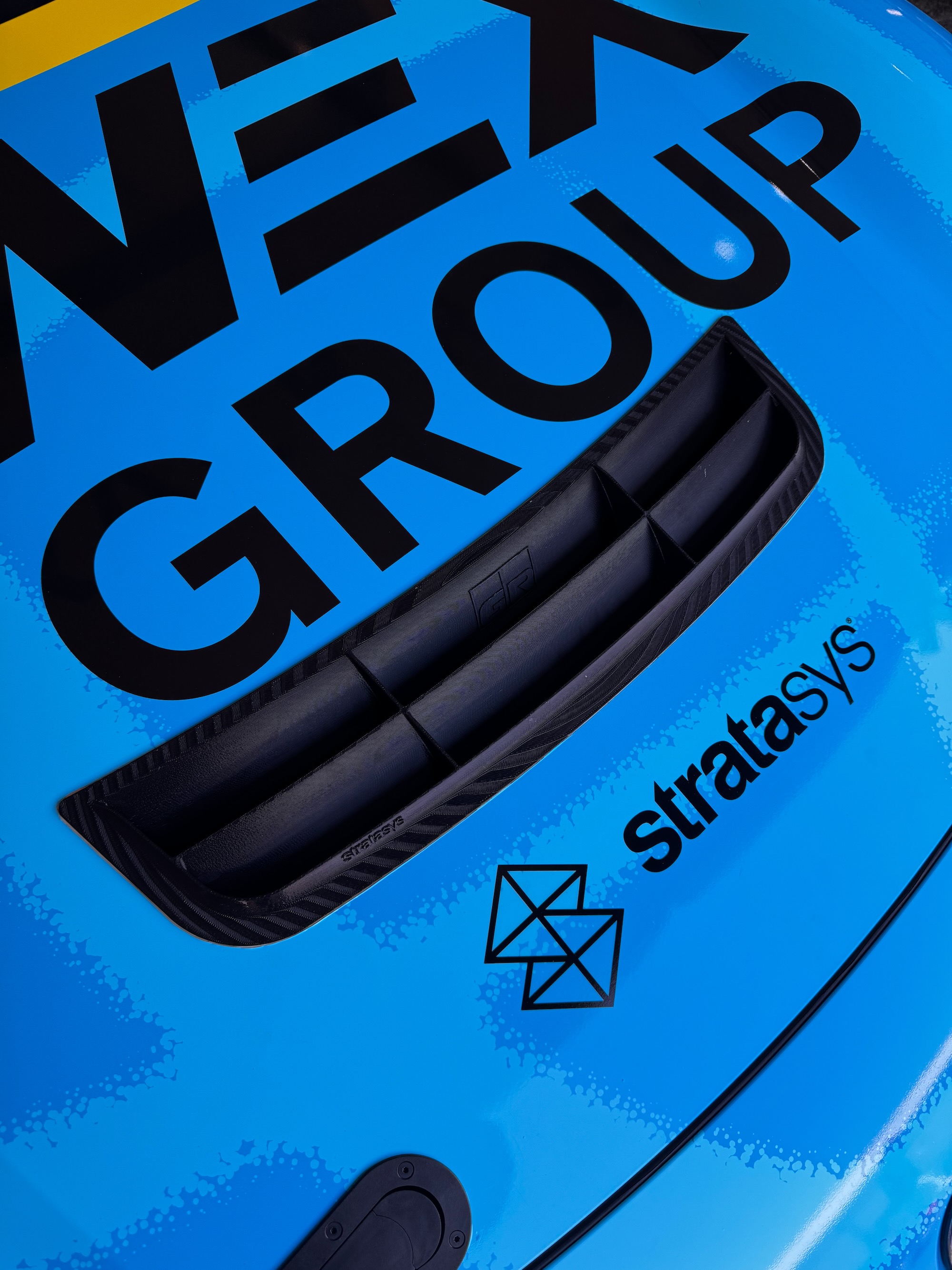 Evidence of 3D printing layers are clearly visible on this hood vent. It is not clear is Stratasys was involved in printing the part or is just a sponsor, but they are a industial 3D printing company.